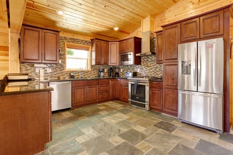 Fully equipped cabin kitchen with ample cabinetry, stove, fridge, microwave, and coffee maker—perfect for cooking meals, morning coffee, and feeling right at home on your stay.