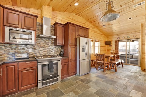 Fully equipped cabin kitchen with ample cabinetry, stove, fridge, microwave, and coffee maker—perfect for cooking meals, morning coffee, and feeling right at home on your stay.