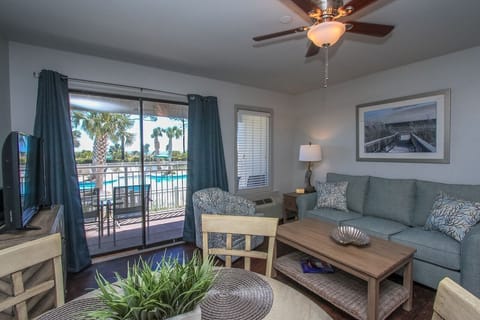 Living room/balcony - The Living Room Area has sliding door access to the Pool/Ocean view Balcony. Upscale furnishings and a flat screen television complete the space.