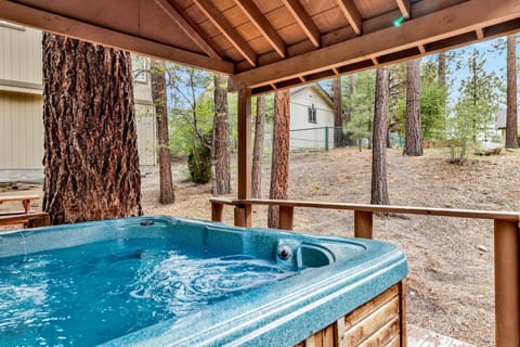 Private outdoor hot tub surrounded by tall pines, perfect for relaxing under the trees after a day of adventure—enjoy peaceful forest views, fresh air, and a truly rejuvenating stay.