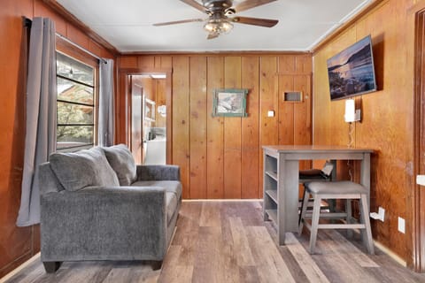 Cozy cabin living room with a  comfy seating, and rustic wood details—perfect for relaxing evenings, movie nights, and unforgettable mountain getaways.