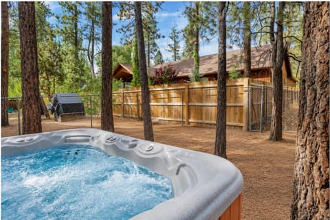 Private outdoor hot tub surrounded by tall pines, perfect for relaxing under the trees after a day of adventure enjoy peaceful forest views, fresh air, and a truly rejuvenating stay.