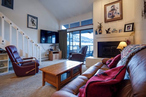 Sink into plush leather seating by your crackling fireplace, where mountain views frame cozy evenings of relaxation and warmth.