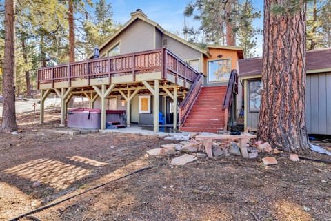 Spacious cabin deck with outdoor dining, BBQ grill, and forest views—ideal for al fresco meals, sunset gatherings, and relaxed mountain living year-round.