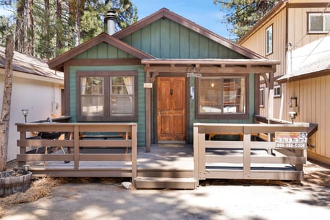 Relax on a spacious covered cabin porch surrounded by towering trees and nature views—perfect for morning coffee, quiet evenings, and peaceful mountain escapes.