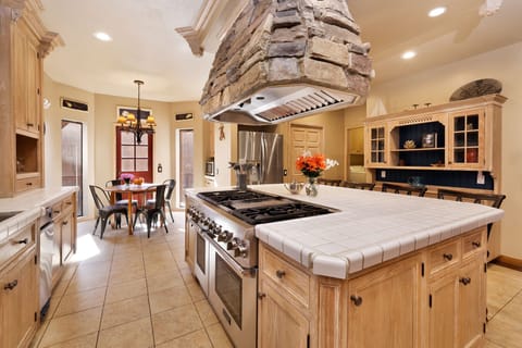 Fully equipped cabin kitchen with ample cabinetry, stove, fridge, microwave, and coffee maker—perfect for cooking meals, morning coffee, and feeling right at home on your stay.