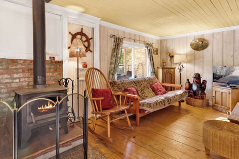 Cozy mountain living room with a fireplace, comfy seating, and smart TV—perfect for relaxing evenings, movie nights, and warm cabin vibes after outdoor adventures.