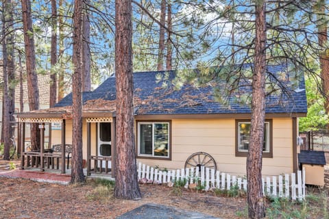 Welcoming cabin entry surrounded by towering pine trees, offering fresh mountain air and a peaceful forest setting—the perfect first impression for your Big Bear Lake getaway.