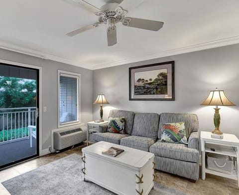 Ocean Dunes 102 - Living Room - New travertine flooring, along with new queen sized sofa bed and easy access to the balcony that seats 4.