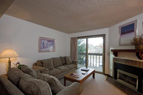 Sink into plush sofas by your private fireplace, where warm lighting and peaceful balcony views create the perfect retreat.