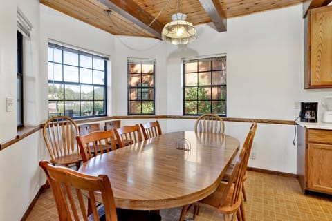 Fully equipped cabin kitchen with warm wood cabinets,stove, fridge, microwave, and coffee maker—perfect for cooking meals, morning coffee, and feeling right at home on your stay.