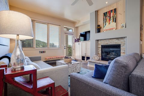 Unwind in your stylish living room featuring plush seating, a cozy fireplace, and entertainment center for perfect evenings in.