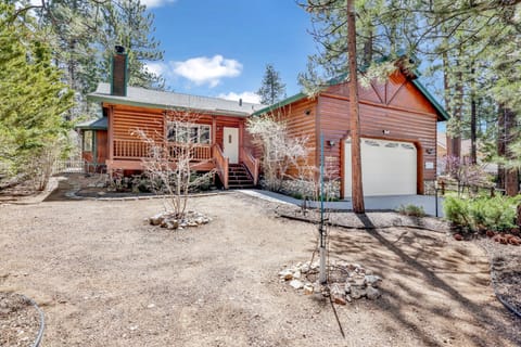 Nestled among mature pines, this classic log cabin features a spacious front porch and a private garage. The natural wood siding and peaceful setting offer a true mountain escape, perfect for year-round outdoor adventures.