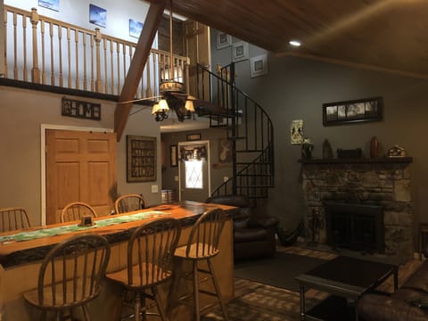 Main dining area. Seating for 8. Recliner and Fireplace. Spiral staircase.