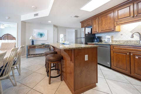 Prepare a savory beach meal in this stylish kitchen with stainless appliances, elegant cabinetry and open island design