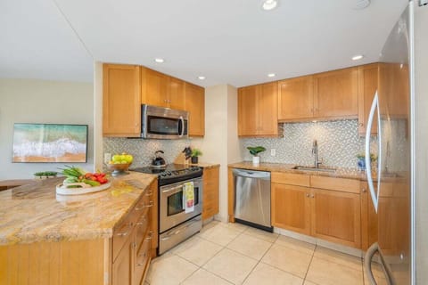 Fully furnished kitchen with stainless steel appliances and wooden cabinets