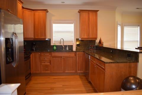 View into the kitchen - granite counters, stainless appliances, new faucet 