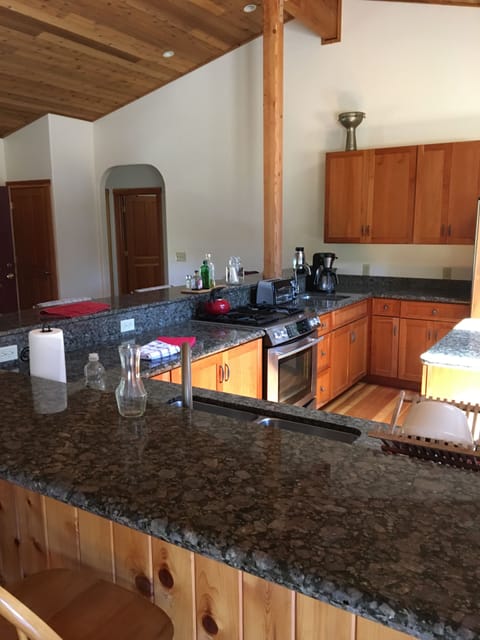 Kitchen bar counters & center island with granite countertops, vaulted ceilings