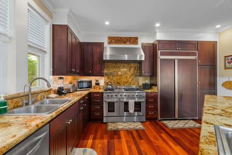 Fully stocked kitchen with stainless steel appliances and built in family-sized refrigerator