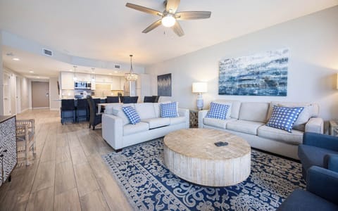 Relax in the inviting living area featuring a sofa with queen sleeper, a stylish coffee table, and a view into the kitchen