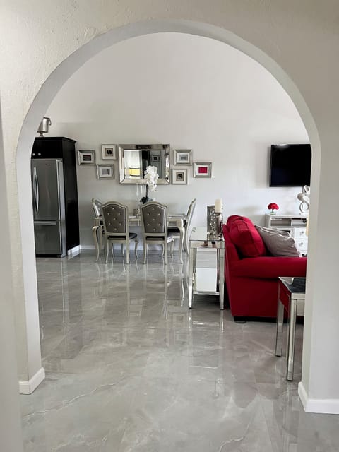 Arched entryway to the open concept living, dining and study areas. 