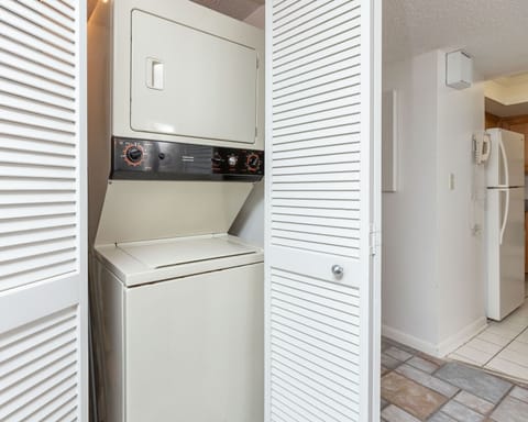 This laundry area features a stacked washer and dryer, providing convenience for your stay