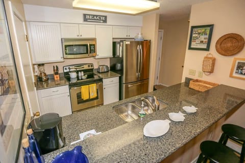 You'll love this fully stocked kitchen with stainless steel appliances and white cabinets.