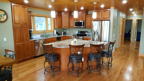 Granite kitchen island provides additional seating with all new appliances