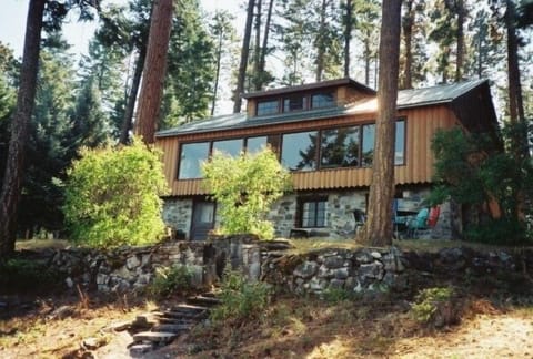 Charming log home offers great views and lake front.