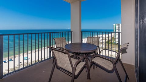 Savor your morning coffee at the outdoor table while enjoying sweeping views of the tranquil beach below
