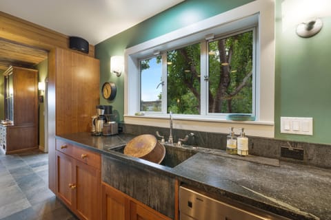 Farmhouse sink with Chicago faucet, soapstone counters on cherry shaker cabinets