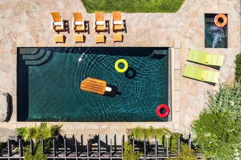 Flyover view of the pool and hot tub /spa area