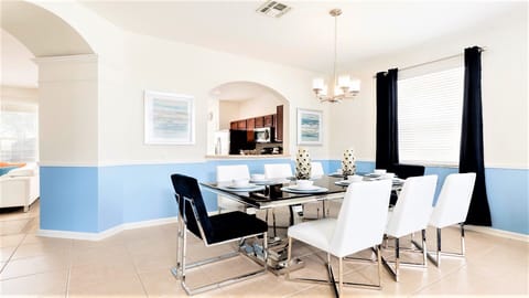 Stylish dining area with modern decor, sleek seating, and an open kitchen view!