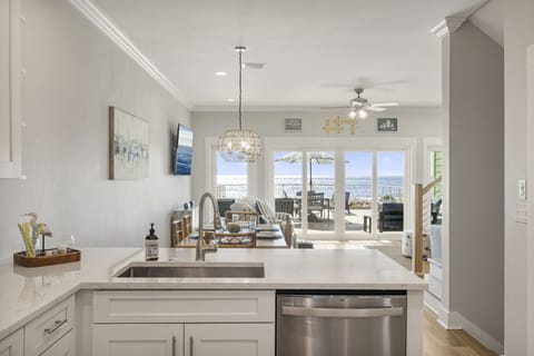 Sudsy sunsets & seaside scrubbing—washing dishes never looked so dreamy! 