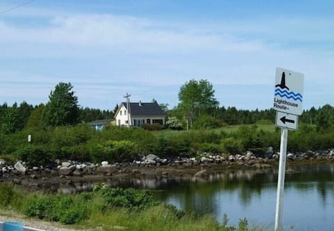 View from the road..Hwy 329..a quiet seaside road around the peninsula. Home is situated on a tranquil and very private 2.25 acres.