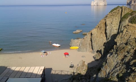 Nice sandy bays at Masua,   Porto Flavia, just 20 mins from San Benedetto.