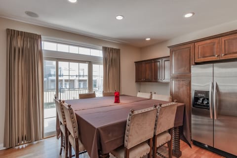 A tall dining table in the kitchen is just one of the many places set up to eat.