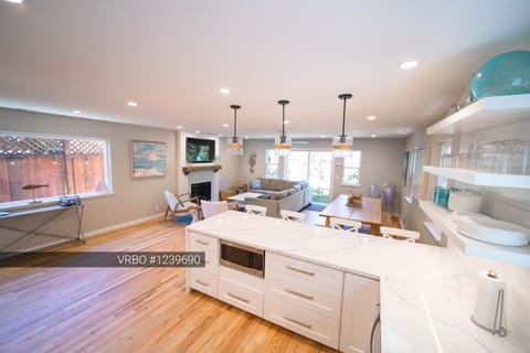 Kitchen view to the TV, new gas fireplace and back patio.