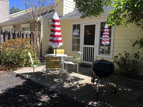fenced back yard with patio and fire pit with additional seating
