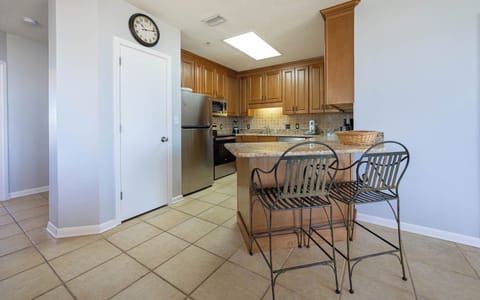 Granite breakfast bar with stylish seating, perfect for morning coffee or casual meals in this inviting kitchen