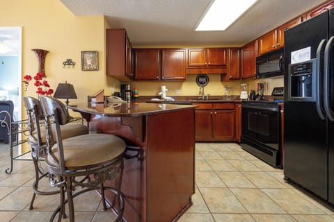 Gather around the stylish bar seating in the kitchen, perfect for casual meals and enjoying the inviting decor