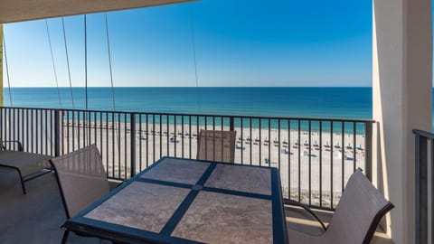 Savor your morning coffee at the outdoor table, enjoying expansive views of the tranquil waters and beach below