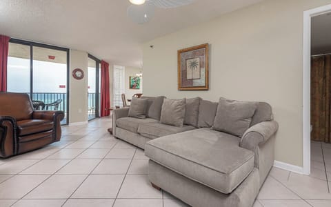Relax on the plush sectional sofa with queen sleeper while enjoying the beachfront balcony view