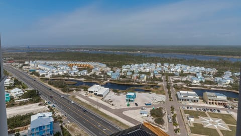 This view showcases a vibrant landscape with charming homes and a serene waterway, perfect for a relaxing getaway
