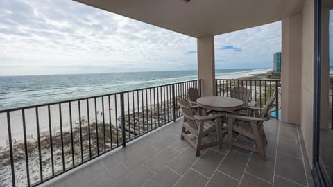 Enjoy meals or drinks at the balcony table while taking in the expansive views of the waves and shoreline