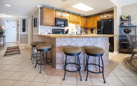 Gather around the spacious breakfast bar with comfortable seating, perfect for coffee and conversations