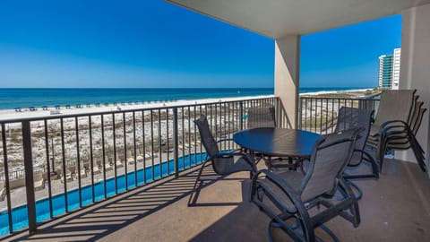 Enjoy meals or relax on the spacious balcony with comfortable seating and beautiful views of the beach