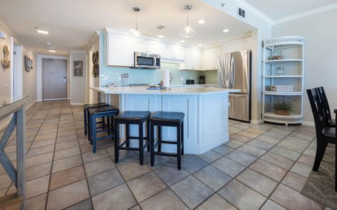 Gather around the kitchen bar with seating for four, perfect for casual meals and conversation in a welcoming space