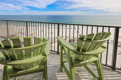 Relax in the green chairs on the balcony, enjoying your coffee with a beachfront view and the serene atmosphere