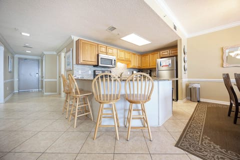 Gather around the breakfast bar with seating for four, perfect for casual meals or morning coffee in this inviting kitchen
